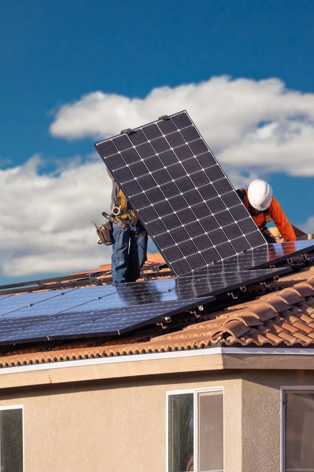 solar law firm photo of 2 installers putting a solar panel on a roof