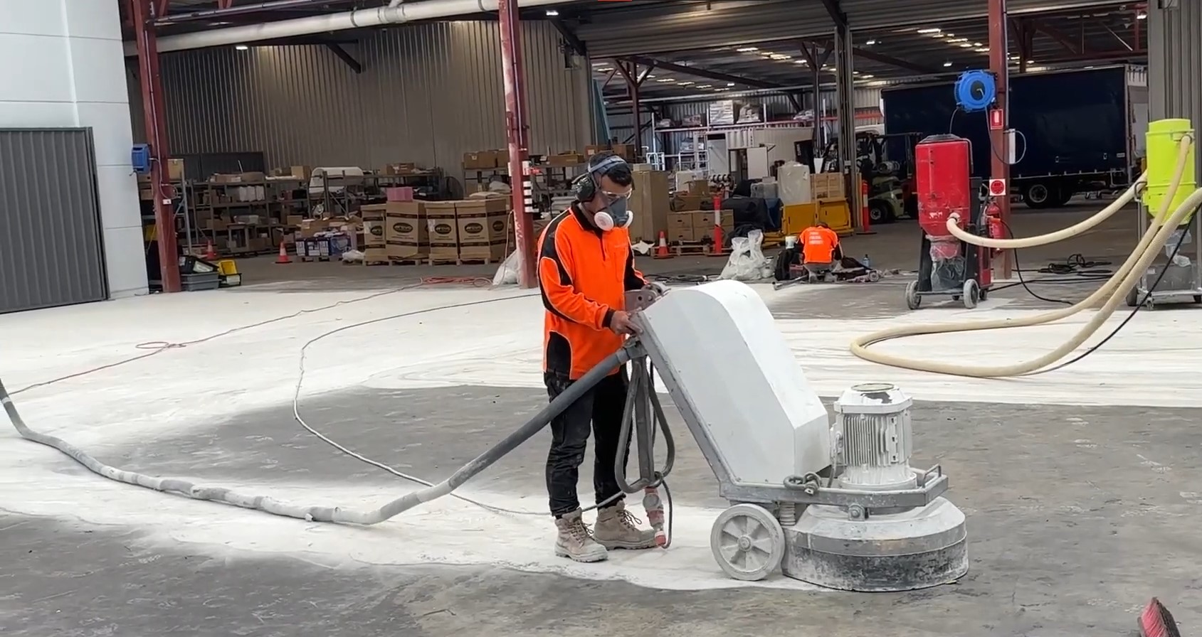 man using concrete grinding machine to grind concrete