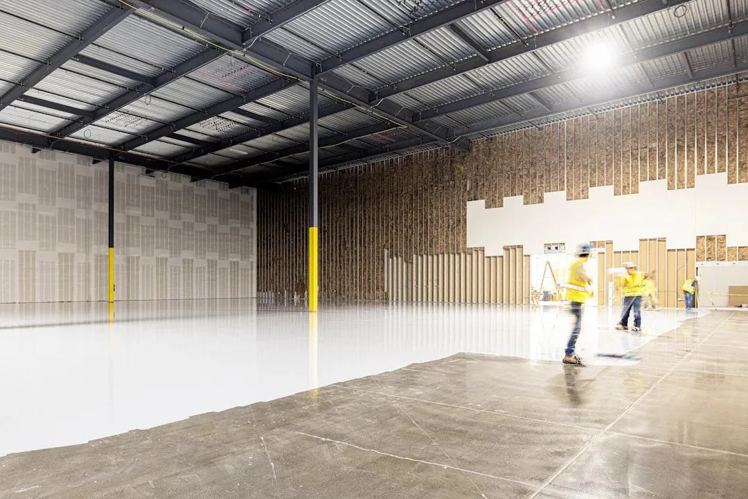 warehouse with concrete floor has white epoxy coated on it