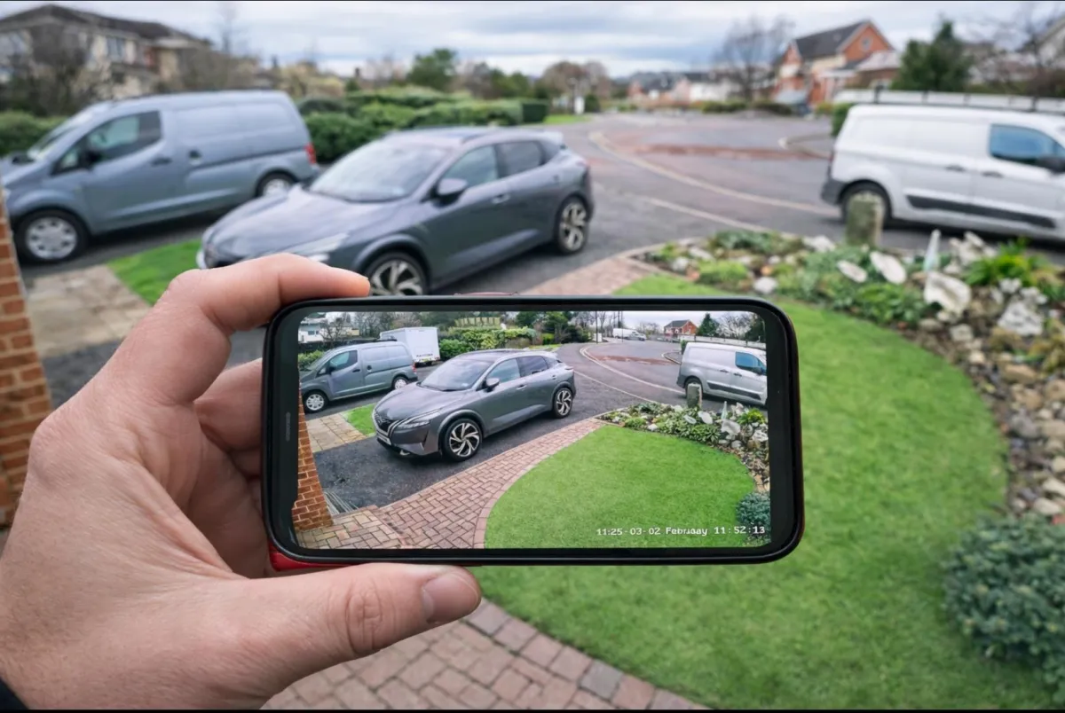 Home CCTV system installation with mobile access showing driveway