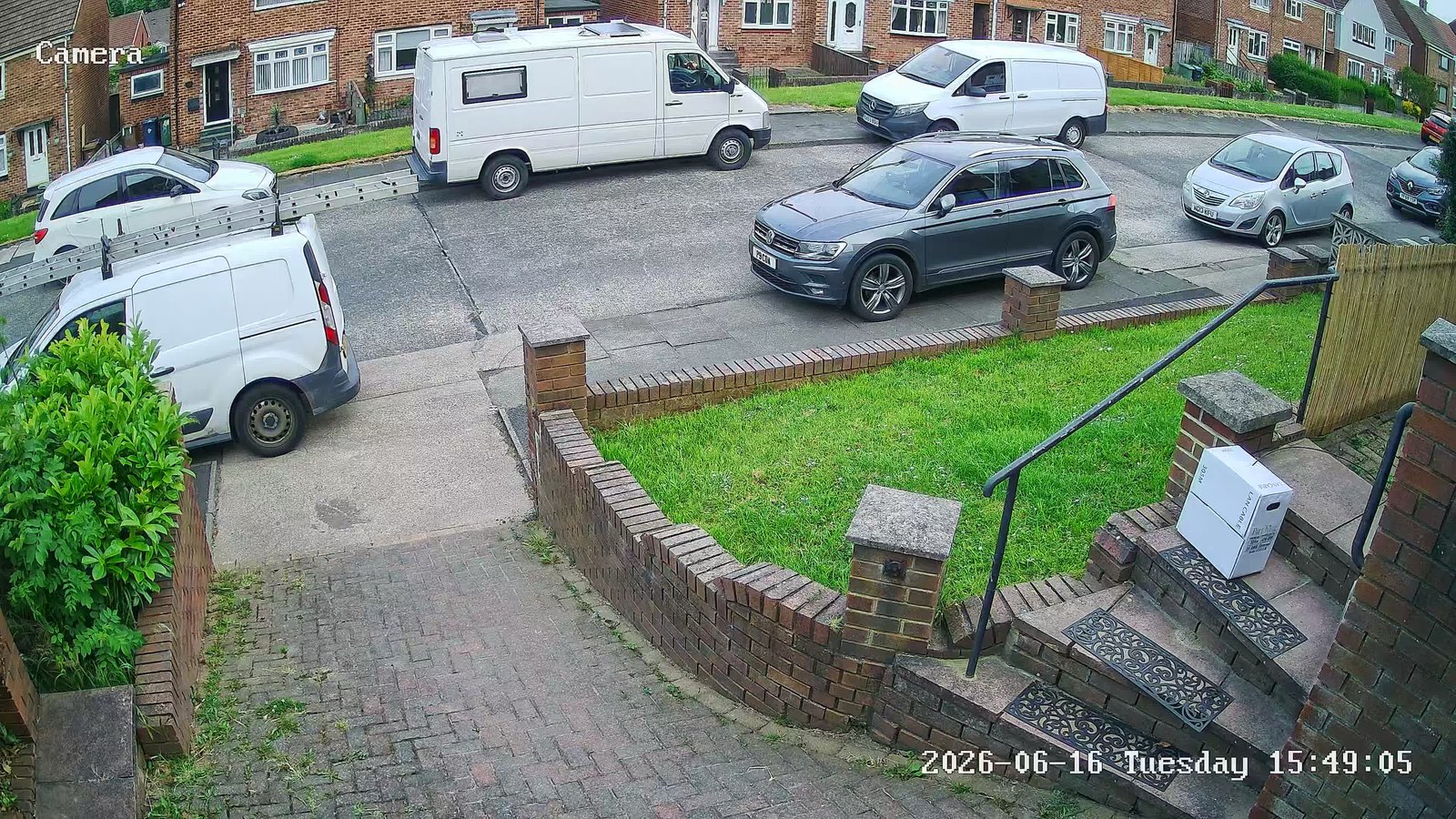 Front CCTV camera view of garden steps, path and the street with parked vehicles, installed by L&B Security