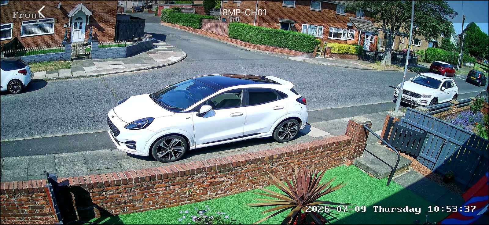 Front CCTV camera covering a parked white car and the street outside, installed by L&B Security