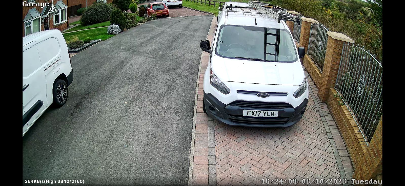 Peterlee CCTV camera view of a block-paved driveway with two white vans