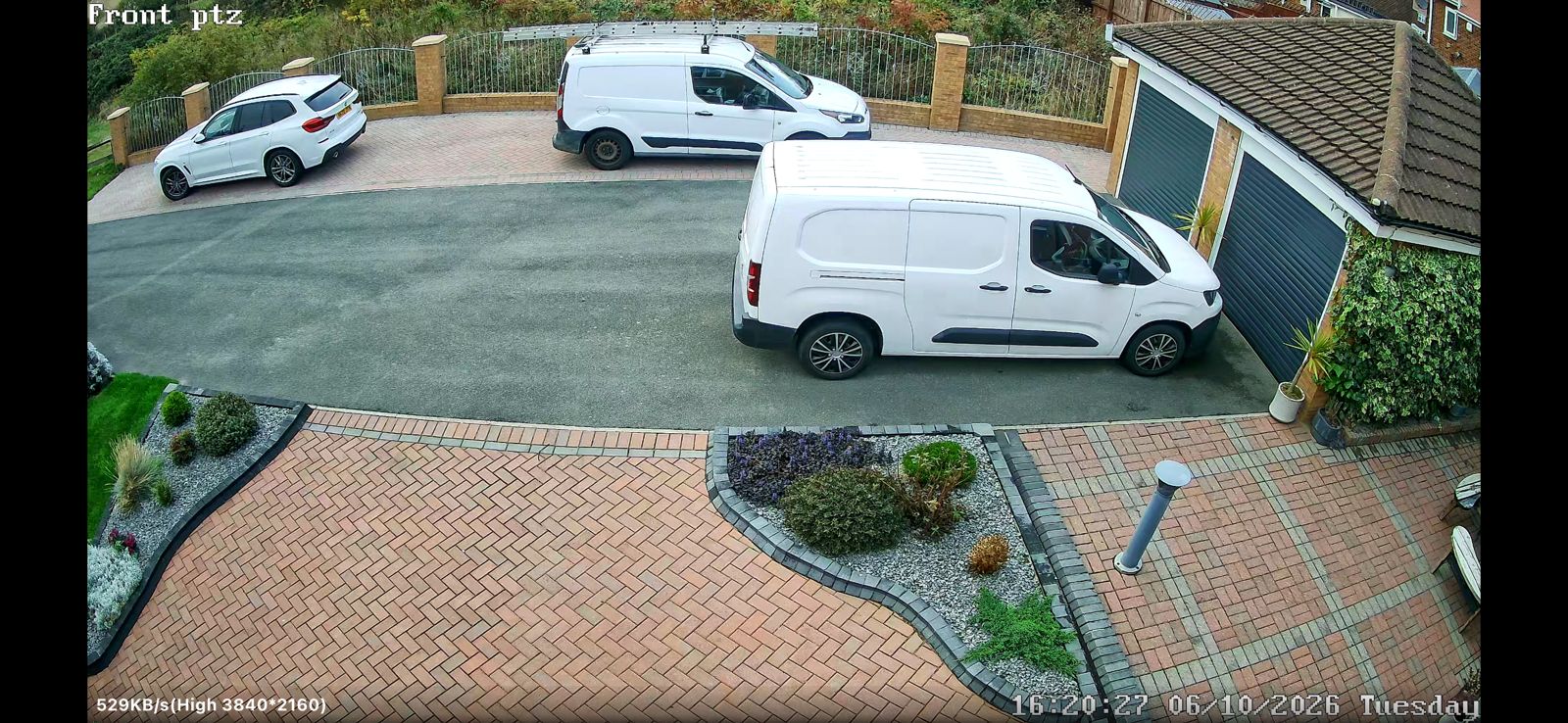 Peterlee CCTV camera view of a driveway with white vans and a block-paved forecourt