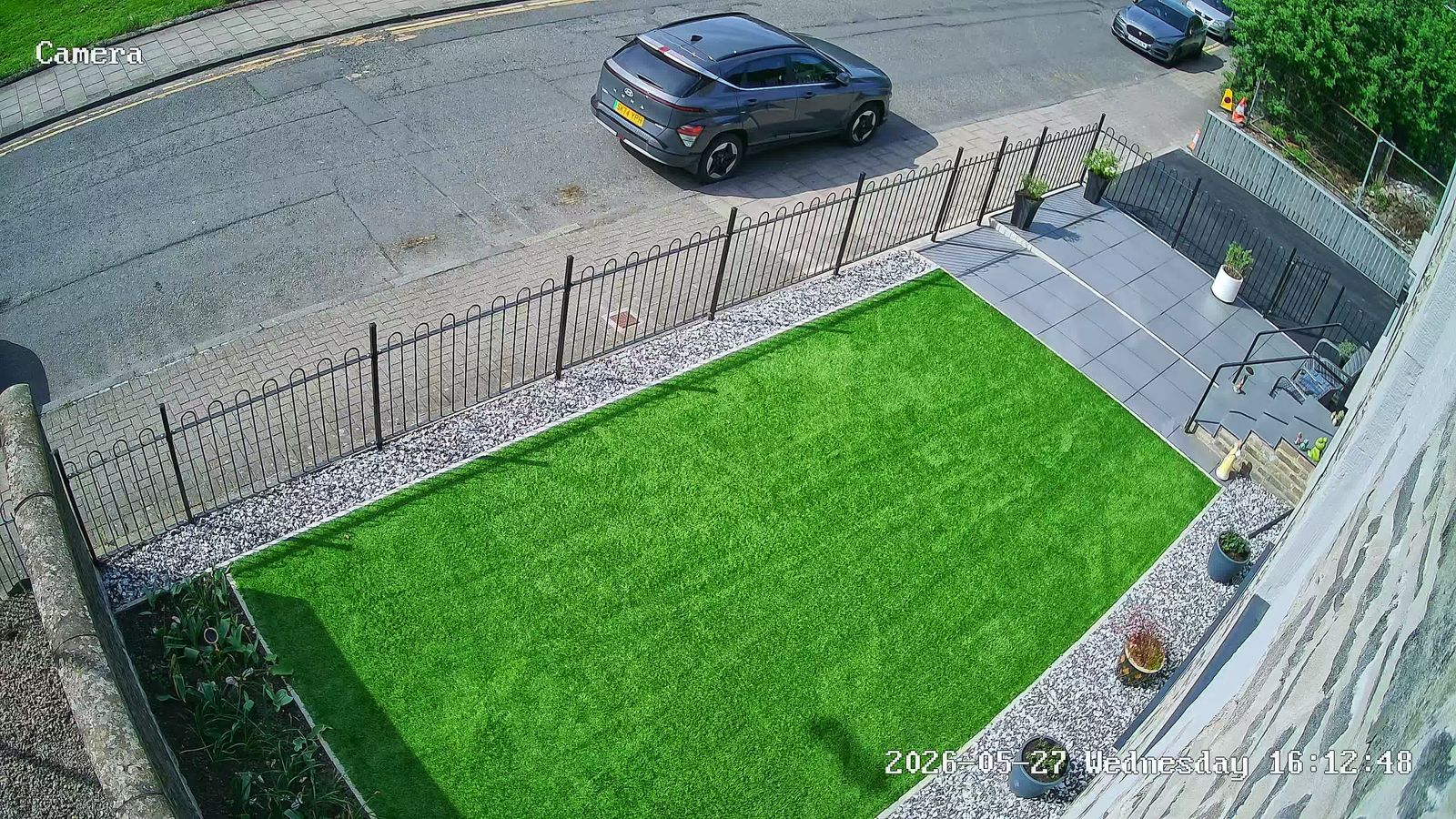 Billingham CCTV camera view of a front garden with railings and a car on the road