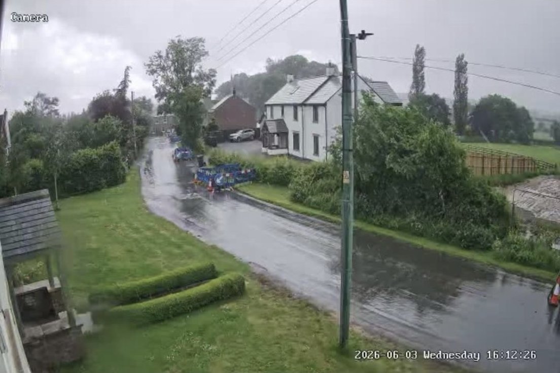 Peterlee CCTV camera view of a wet village road with works vehicles