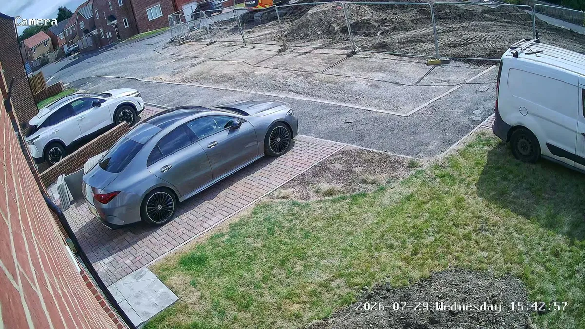 CCTV camera view over a block-paved driveway and lawn at a new-build home in Spennymoor