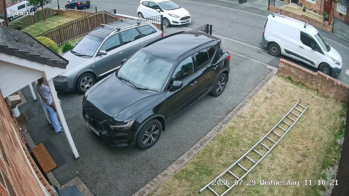 Elevated CCTV view of a front driveway with two cars and a porch at a home in Spennymoor