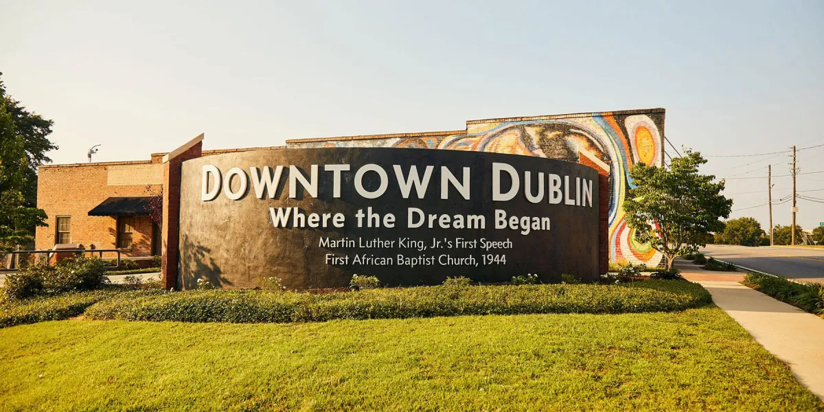 Downtown Dublin welcome sign with mural art and slogan ‘Where the Dream Begins’ at city entrance