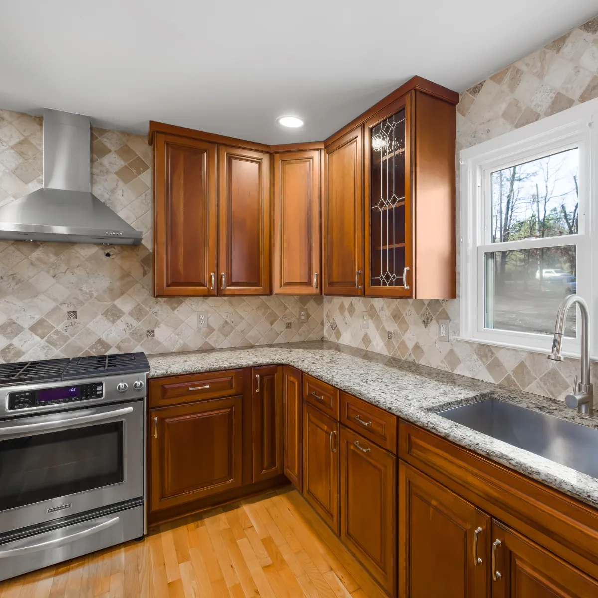 Finished basement with new carpet, recessed lighting, and large windows providing natural light.