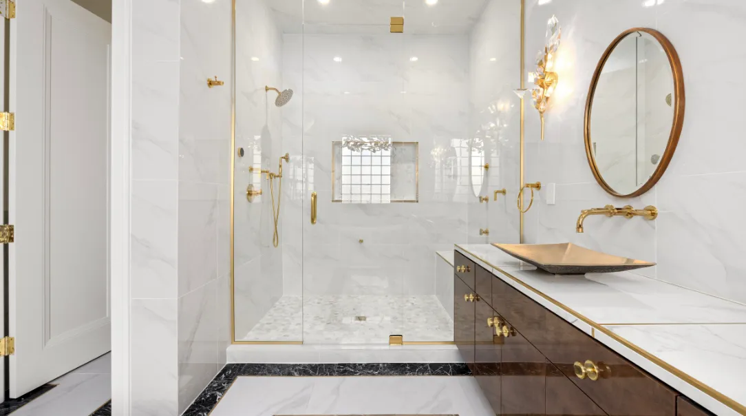 Luxury kitchen remodel with custom wood cabinetry, white quartz countertops, large center island, modern pendant lighting, and stainless steel appliances.