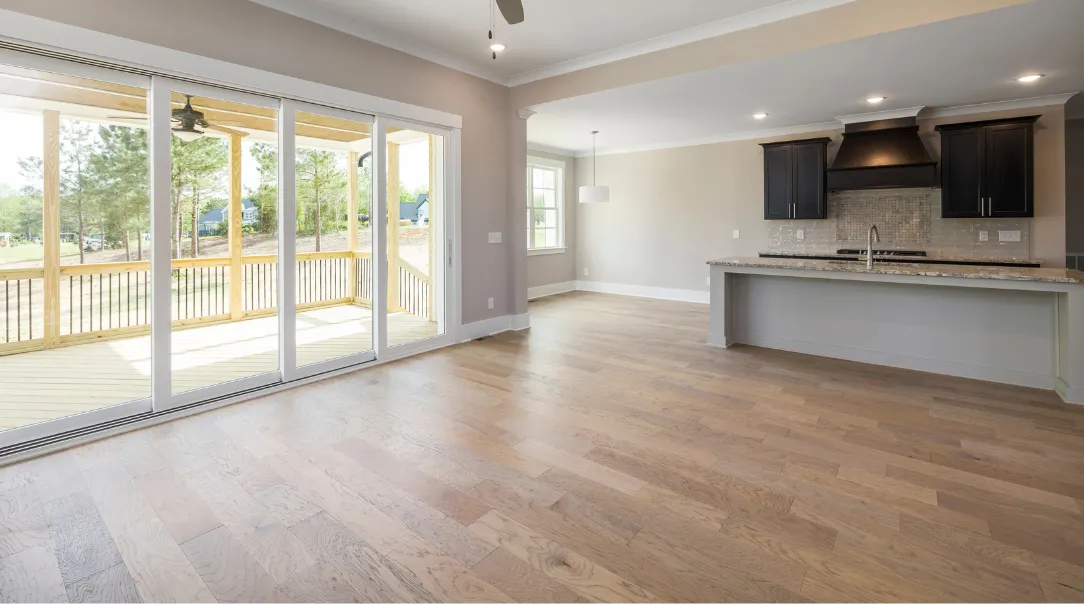 Luxury kitchen remodel with custom wood cabinetry, white quartz countertops, large center island, modern pendant lighting, and stainless steel appliances.