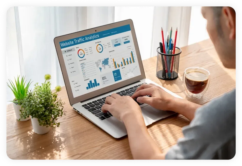Person reviewing website traffic analytics on a laptop, emphasizing the importance of tracking results for effective SEO services in Dallas.
