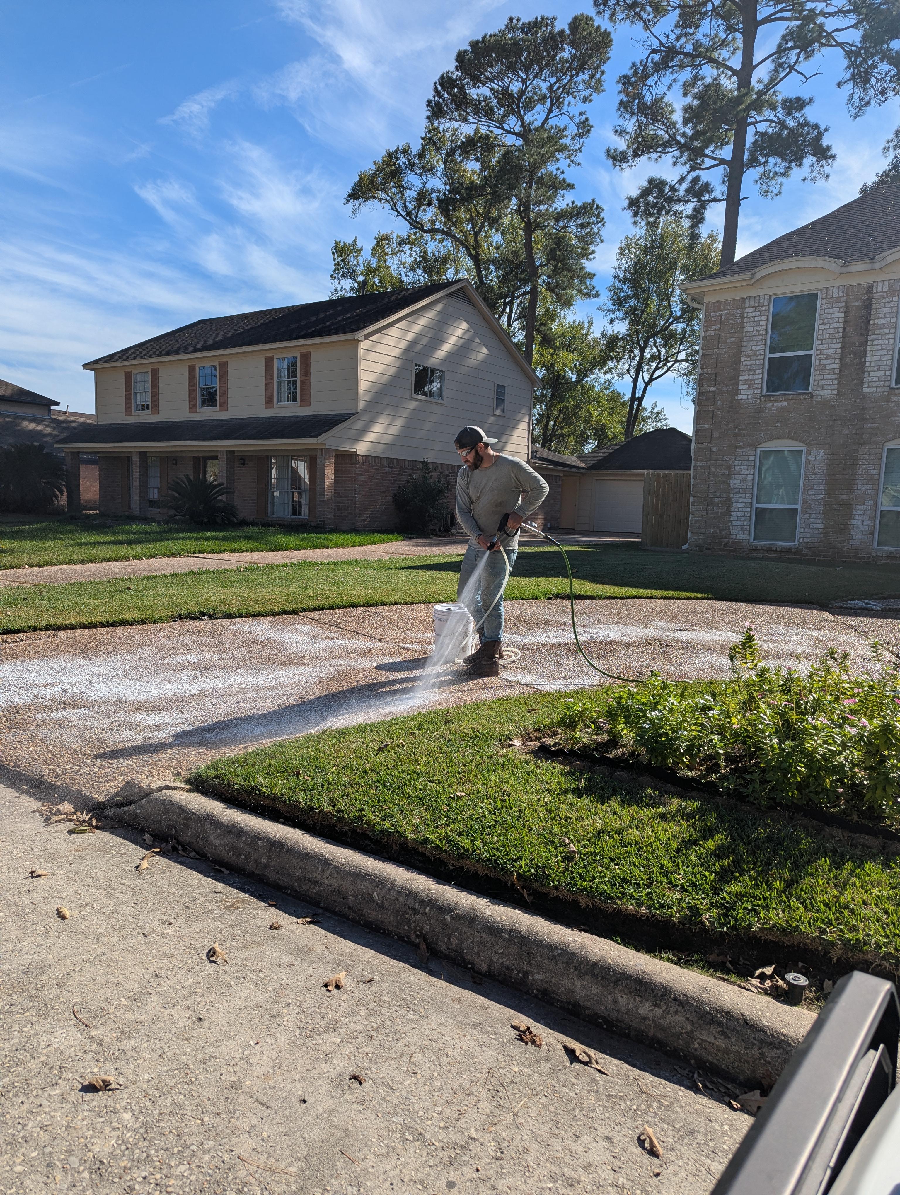 Residential driveway pressure washing in Houston TX using a professional surface cleaner to restore concrete driveways