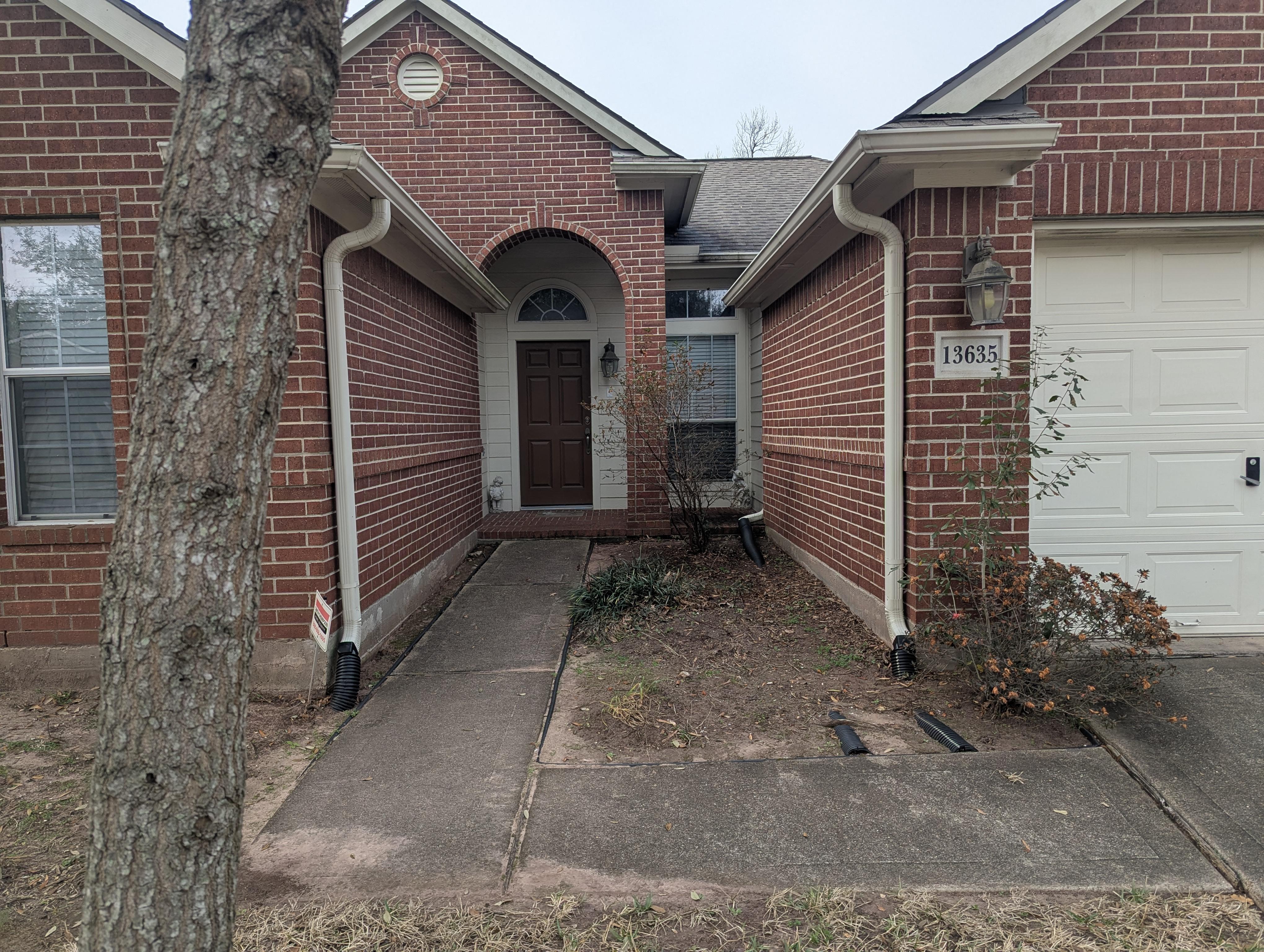 Professional house soft washing service in Houston TX removing mold, mildew, and algae from residential brick siding