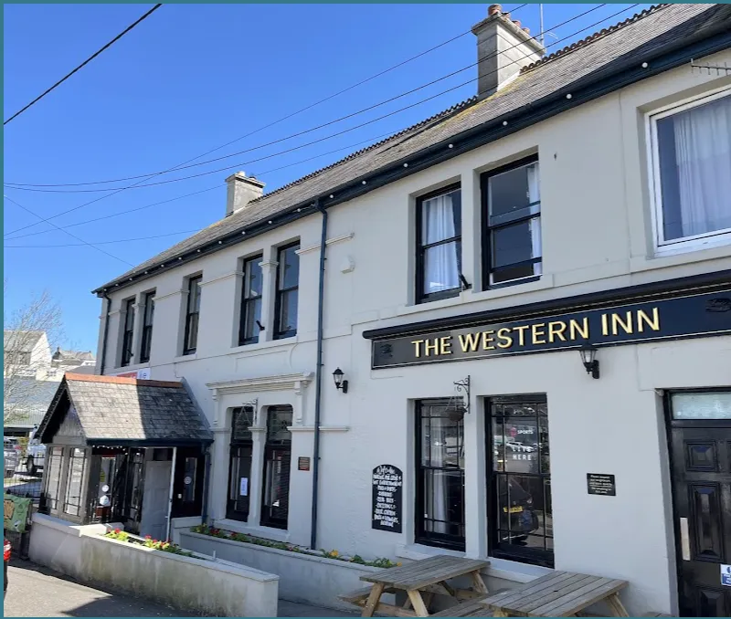 man in black leather jacket and black pants standing near the store