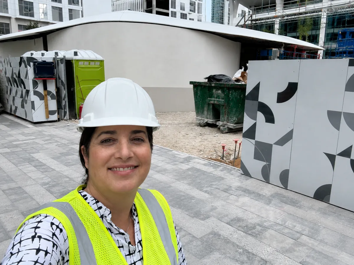 Carolina Baffigo on a commercial job site reviewing cladding installation