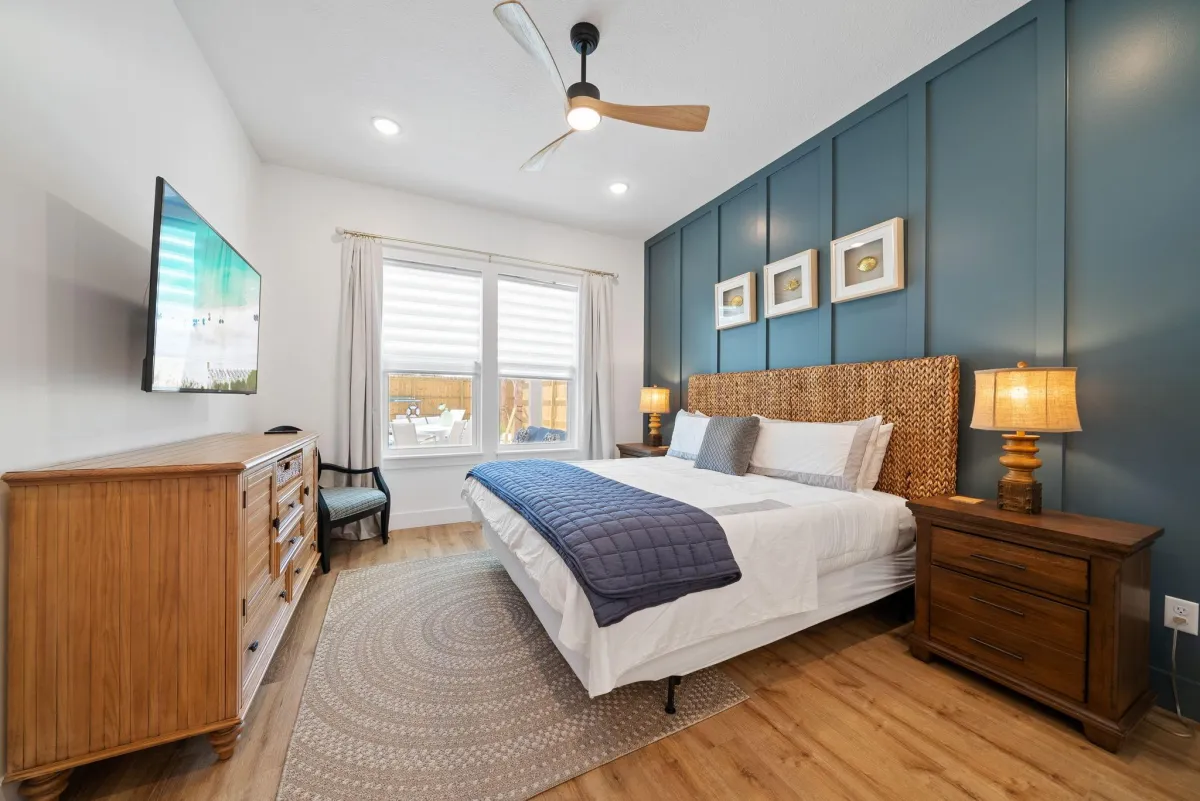 a living room with white furniture and wood floors