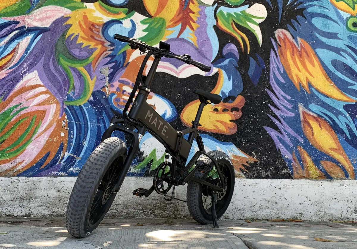woman in white shirt and blue denim jeans riding white and black scooter during daytime
