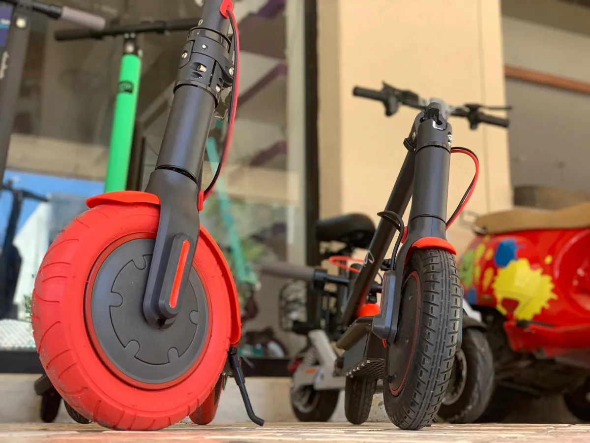 red and white motor scooter