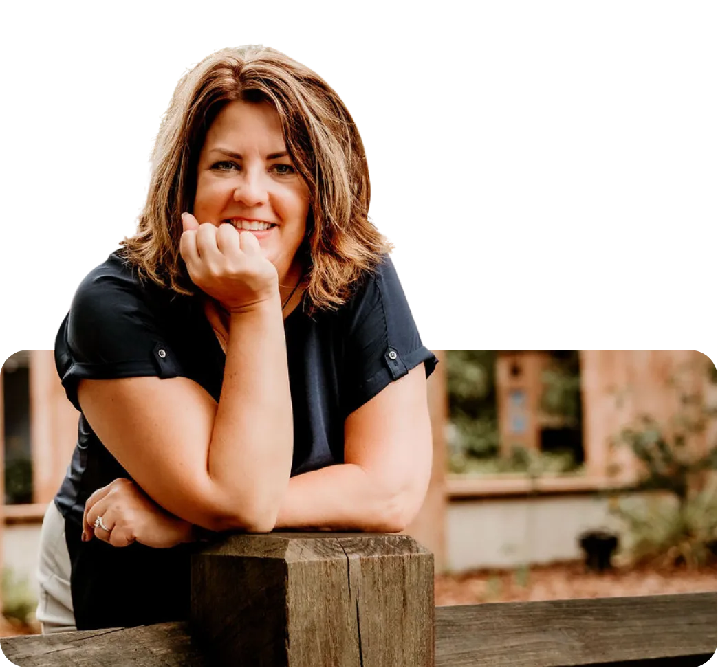 A smiling, confident woman in her 30s sits on a sunlit porch, holding a mug, with a gentle, hopeful expression. The background is softly blurred, evoking warmth and comfort. She wears casual, modern clothing and exudes calm assurance, representing a stepmom embracing her journey.