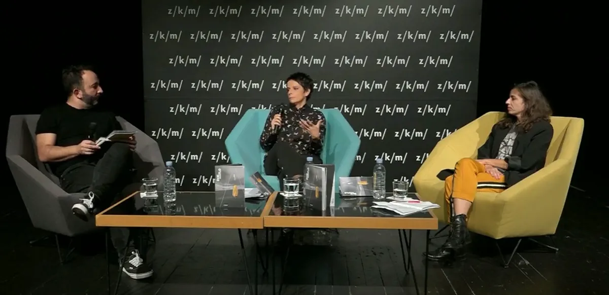 Panel discussion on the ZKM stage with Tihana Klepač, Srđan Sandić and Vedrana Klepica seated around a table of Svjetlo pada programme notes, before the play’s Zagreb premiere.