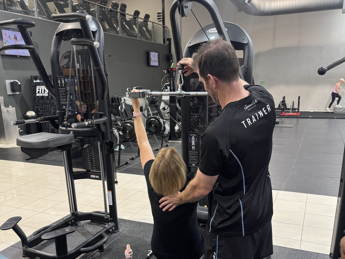Ian Pedler coaching a client on the cable machine at Goodlife Burleigh
