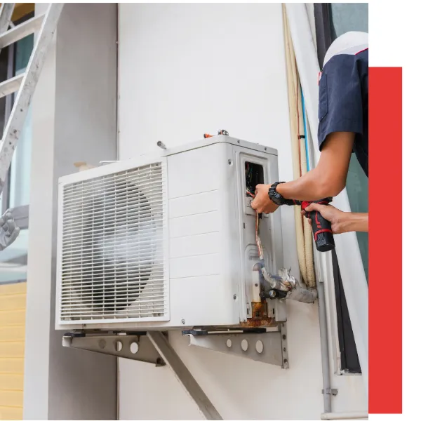 Technician repairing a split system air conditioner, emphasizing HVAC maintenance and efficiency.