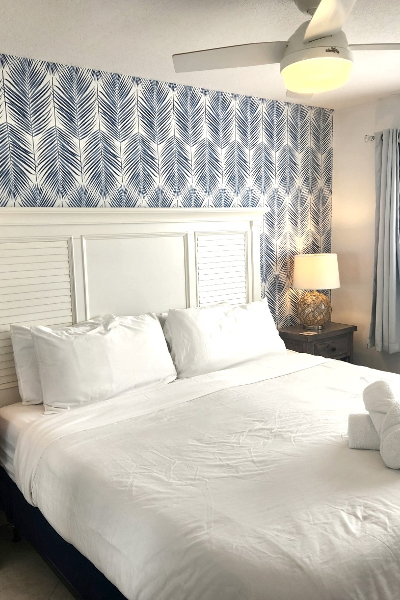 woman setting sheets on bed