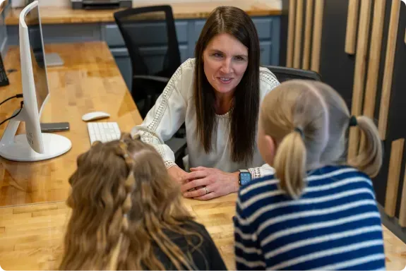 speech therapist talking to 2 children
