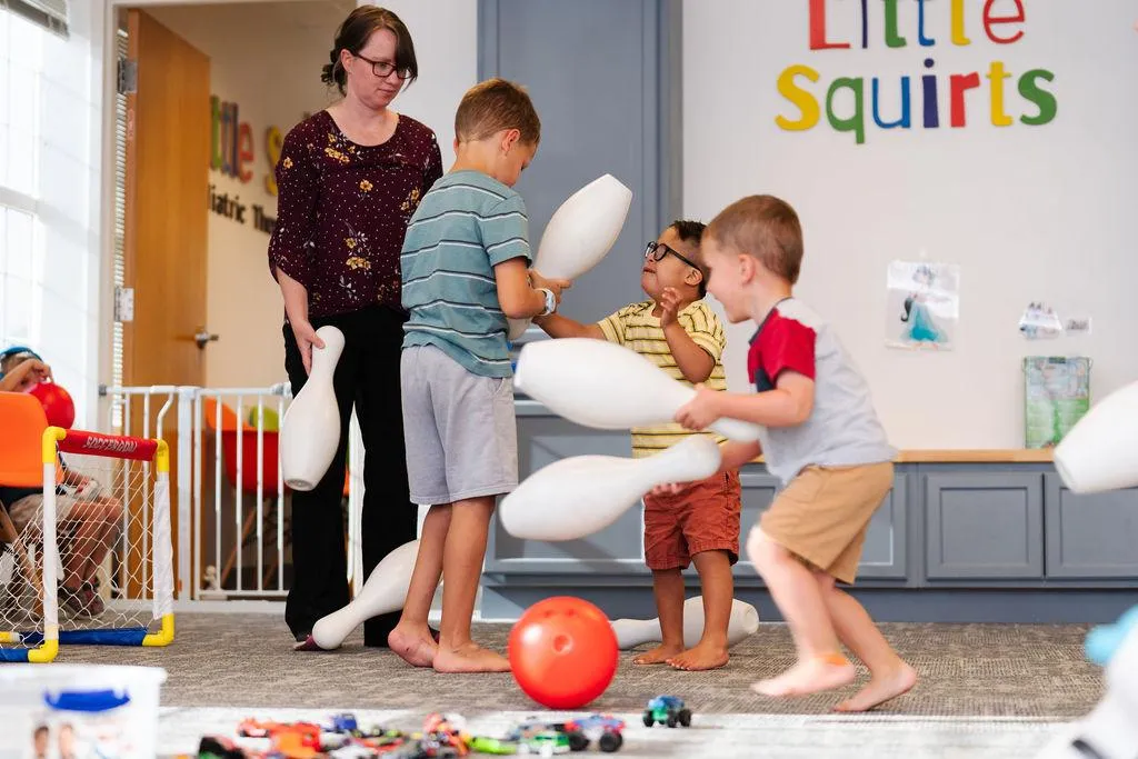 speech therapist talking to 2 children