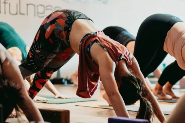 Person practising Downward Facing Dog yoga pose with correct alignment — hips high, spine long