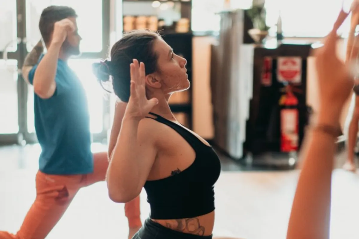 Student performing a chest-opening stretch at One Big Heart yoga studio in Camden NSW to relieve shoulder tension