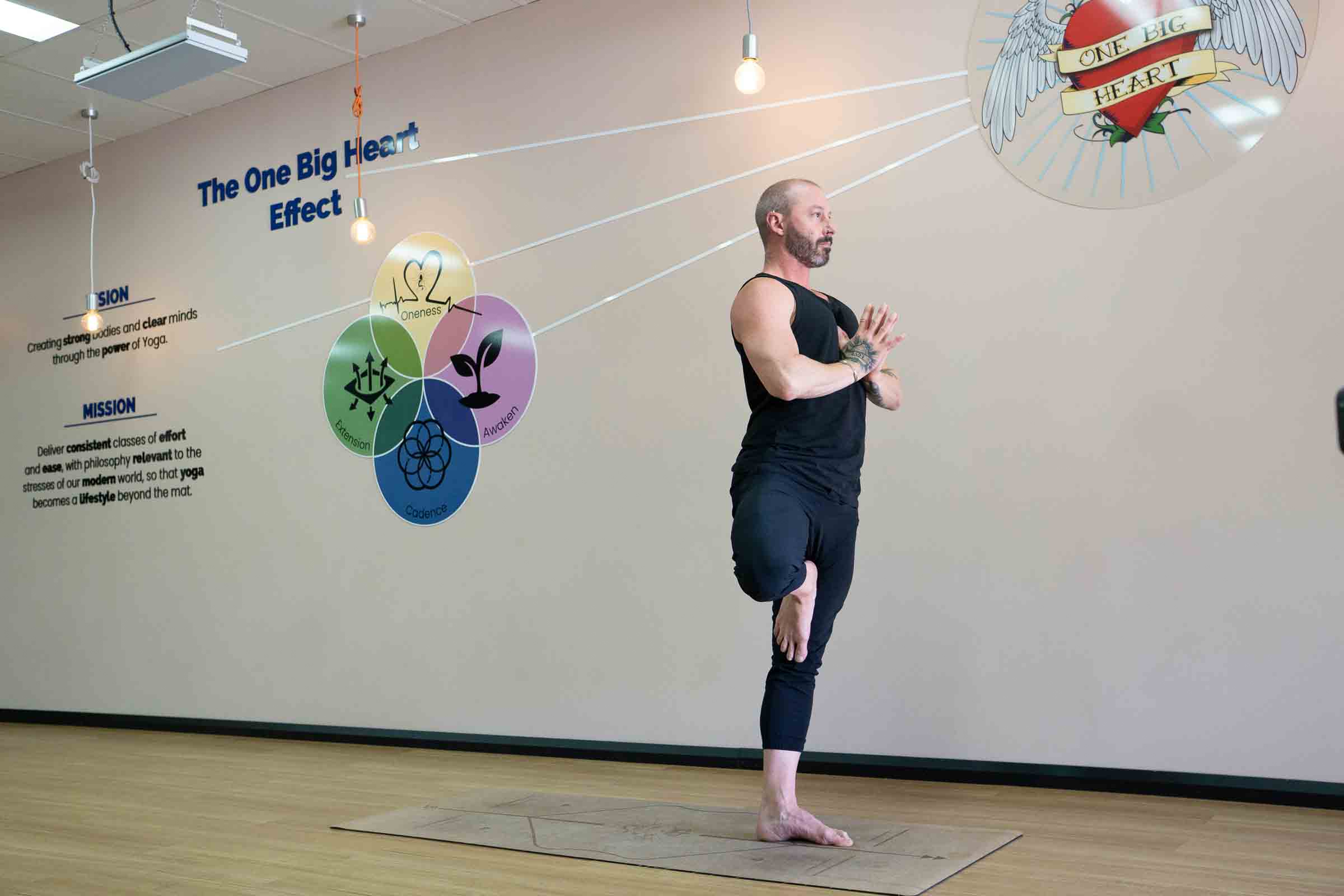 Student holding Tree Pose balance at One Big Heart yoga studio Camden