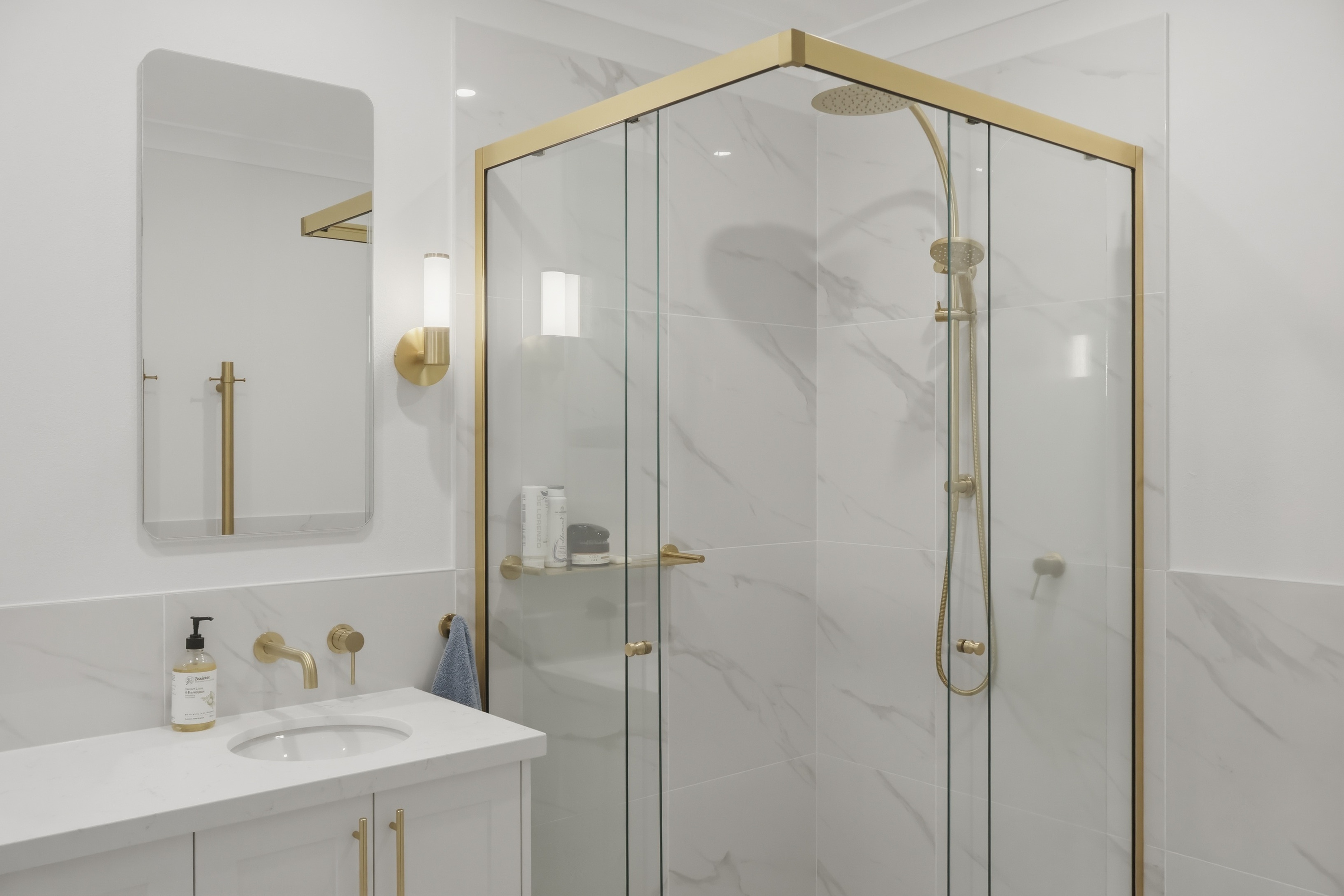 Frenchs Forest bathroom renovation with frameless glass shower and brushed gold tapware