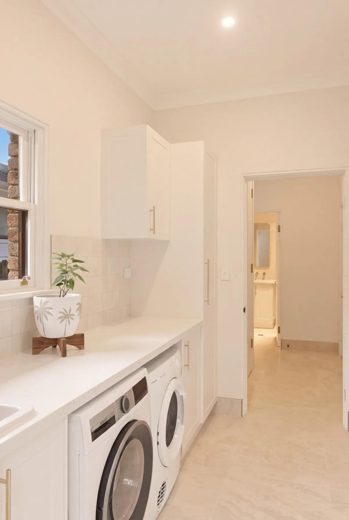 Custom laundry renovation with built-in cabinetry by Sharpe & Co