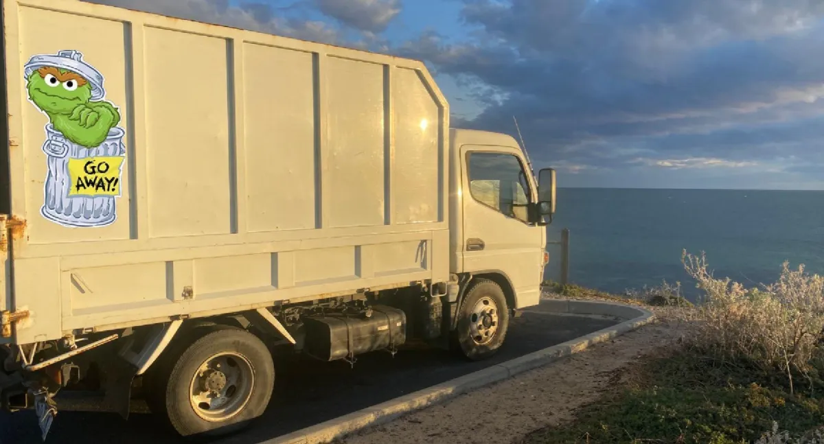 Man with trash bag in park cleanup