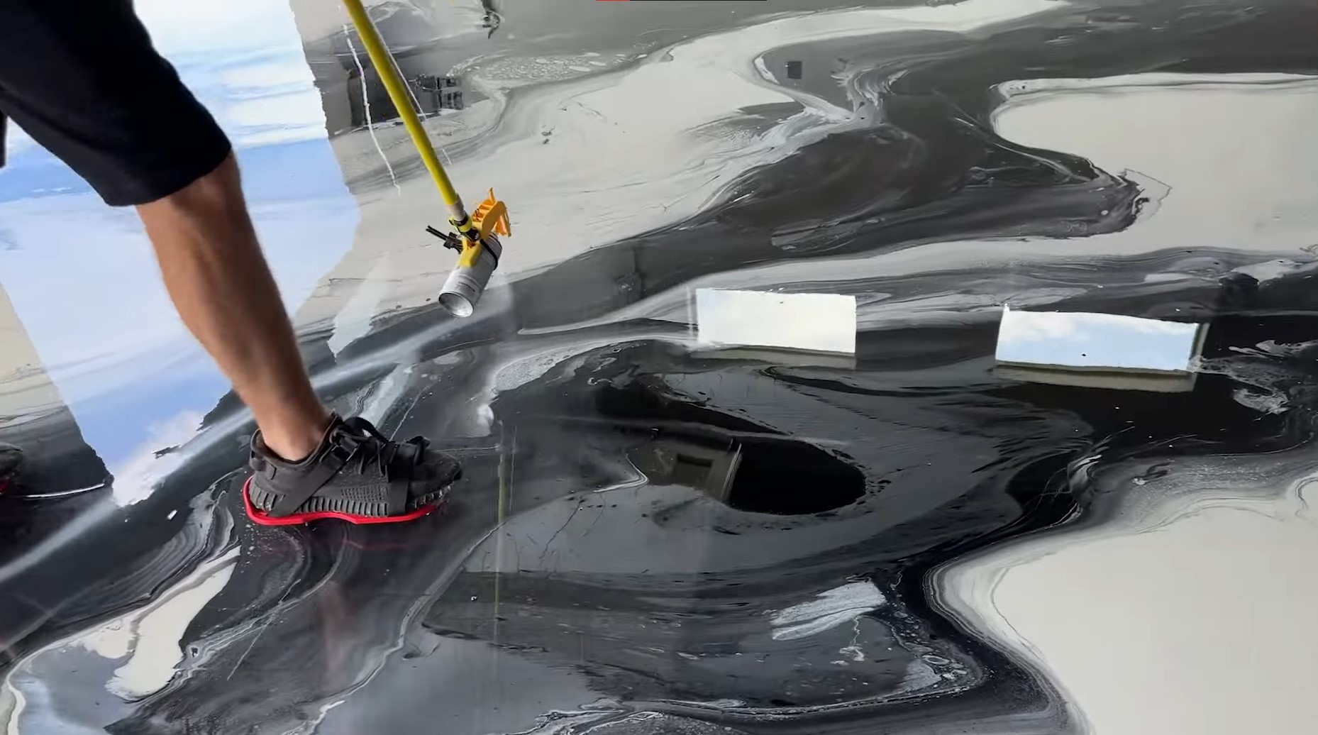 metallic epoxy floor being sprayed on