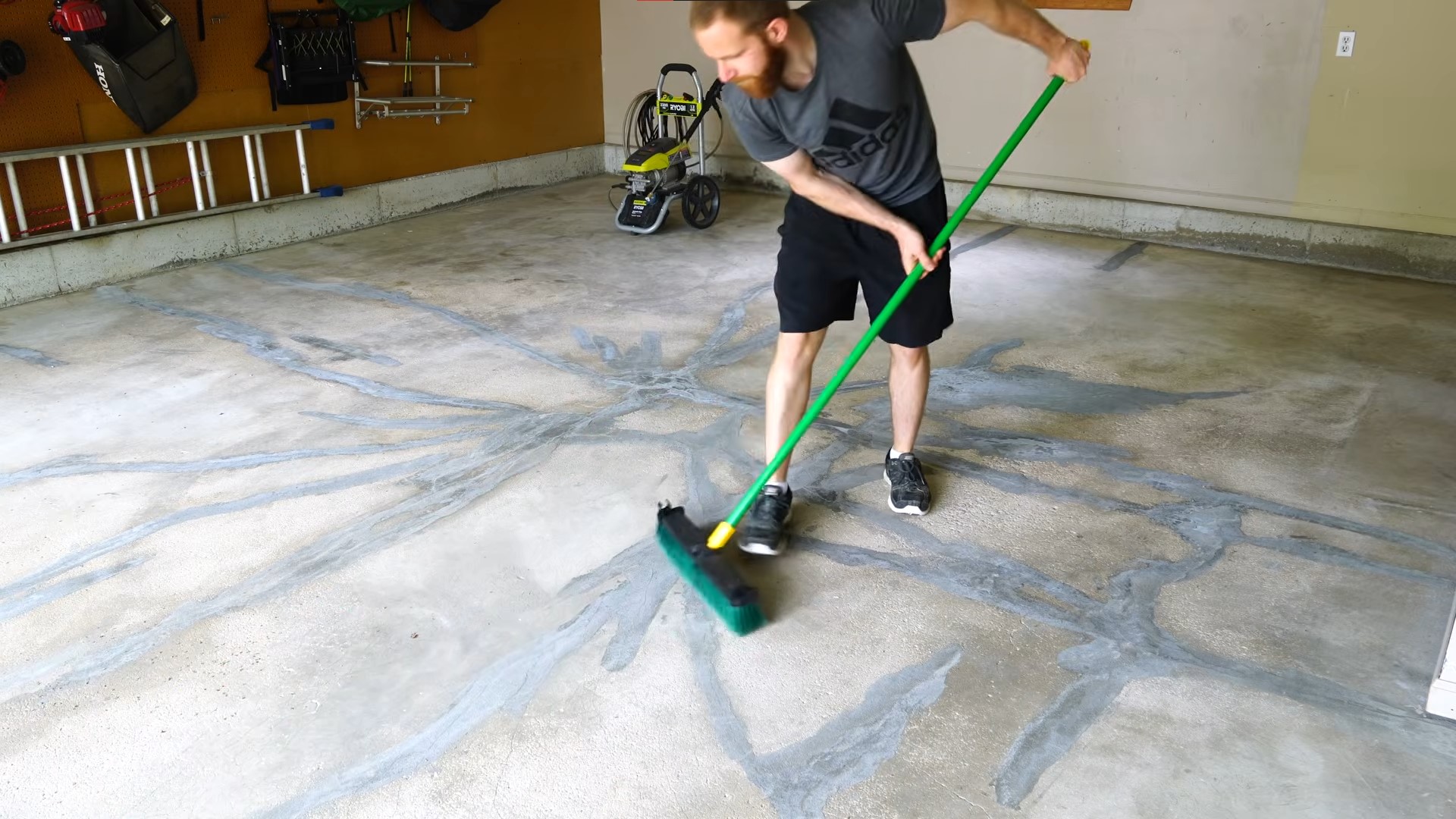 using broom to sweep concrete floor
