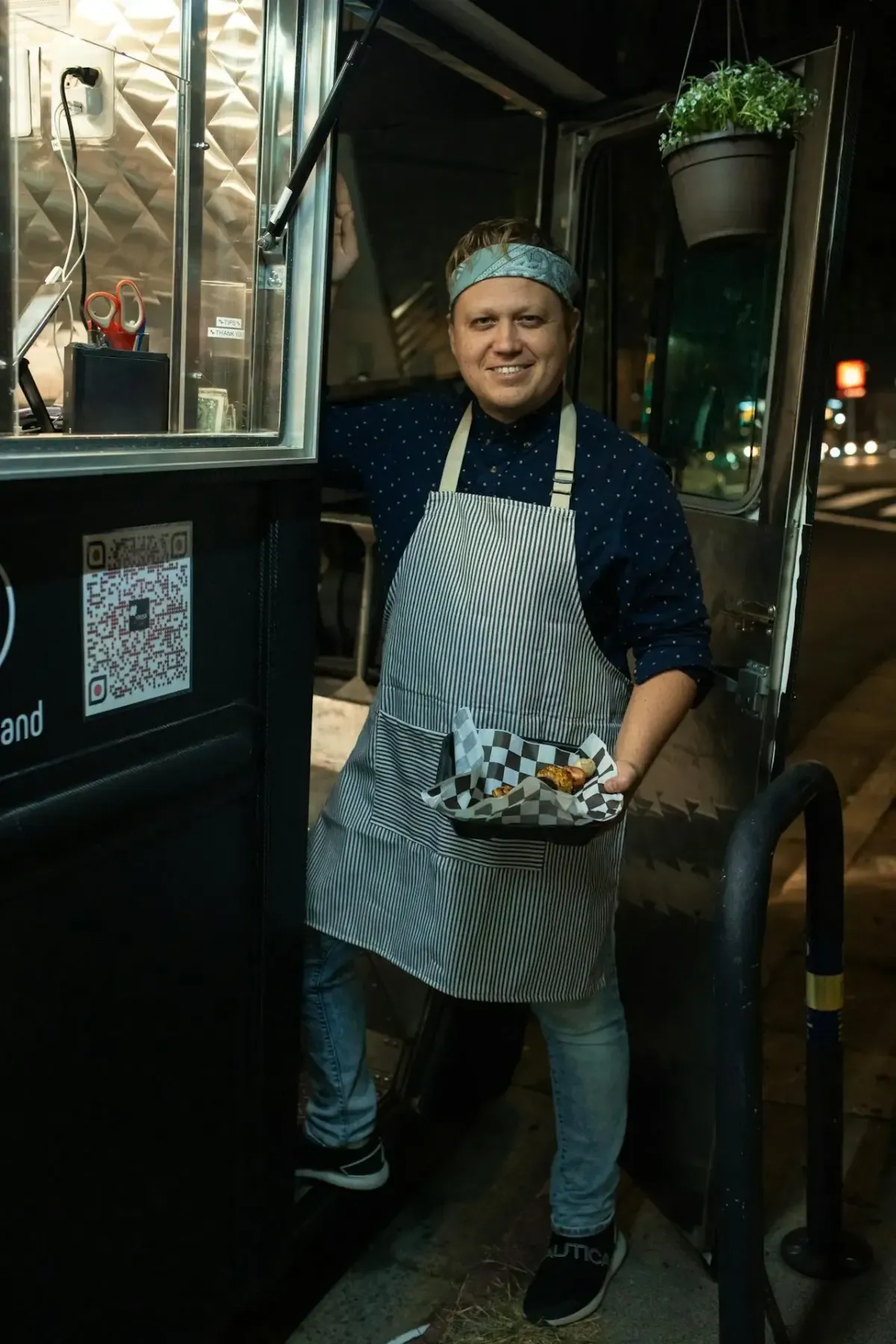 man holding a food standing near a food truck
