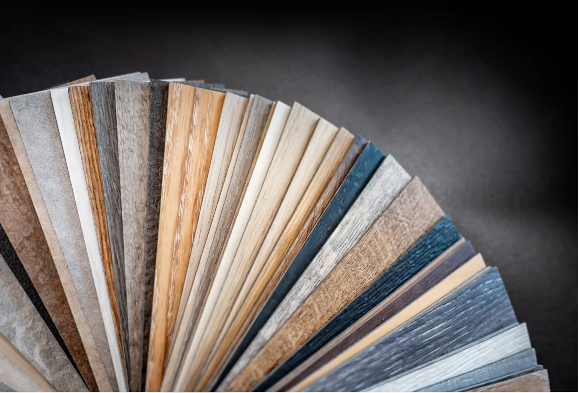 Luxury vinyl and laminate flooring samples in multiple colors and styles