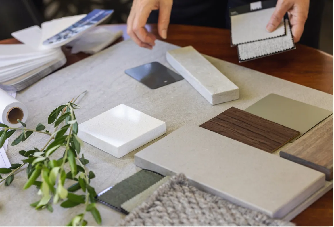 Flooring and material samples being reviewed during a custom project consultation