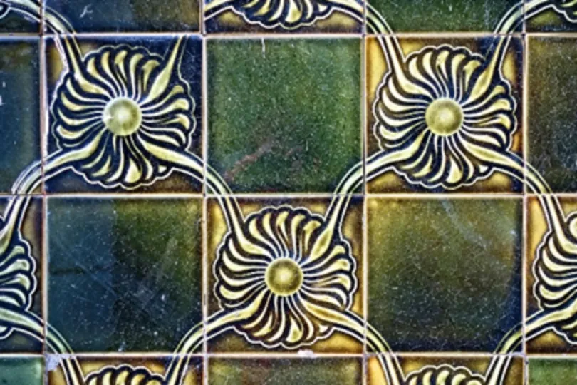 Decorative patterned tile flooring sample with floral design