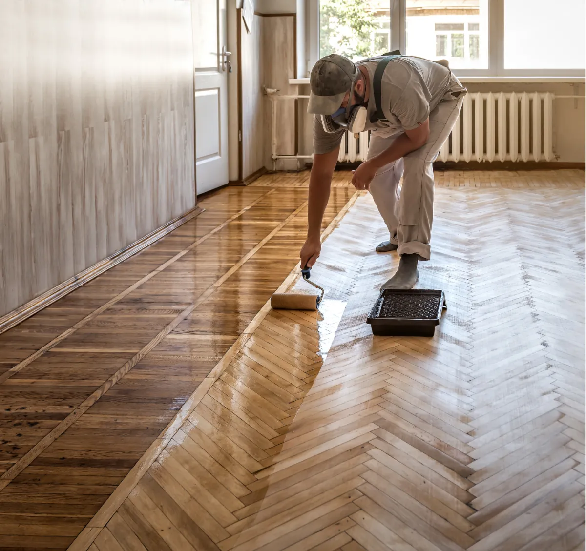 Flooring professional refinishing a custom hardwood floor