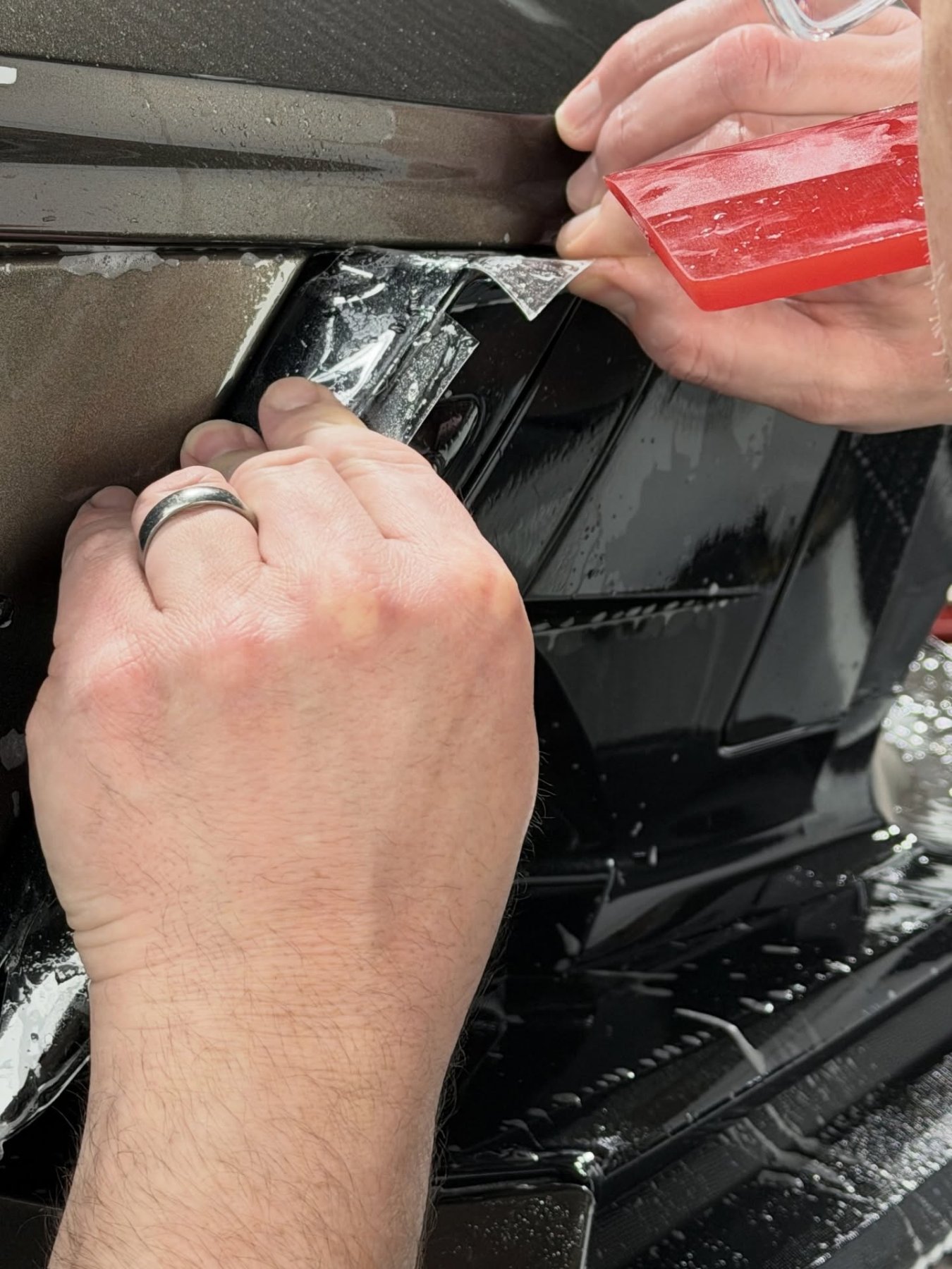 Hand-trimming paint protection film on gloss black trim