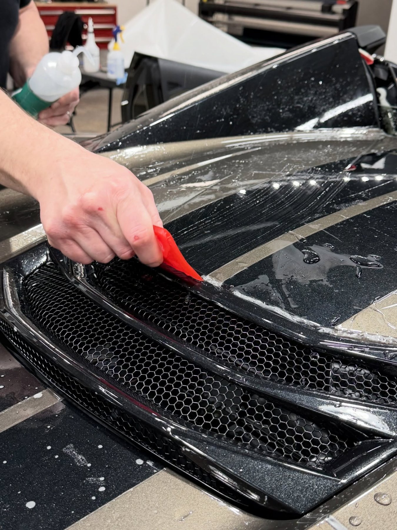 Working paint protection film into a front grille
