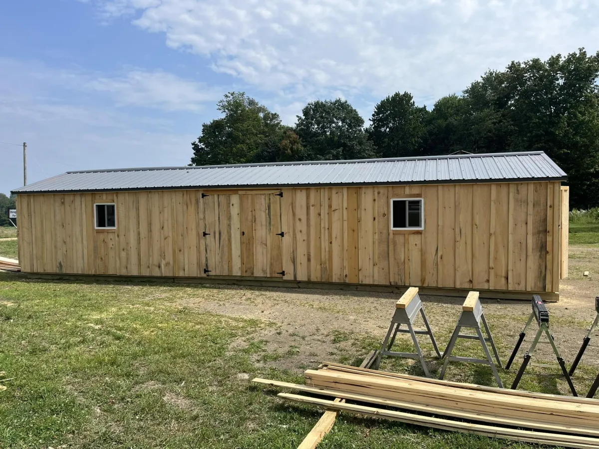 a wooden building with a fence around it
