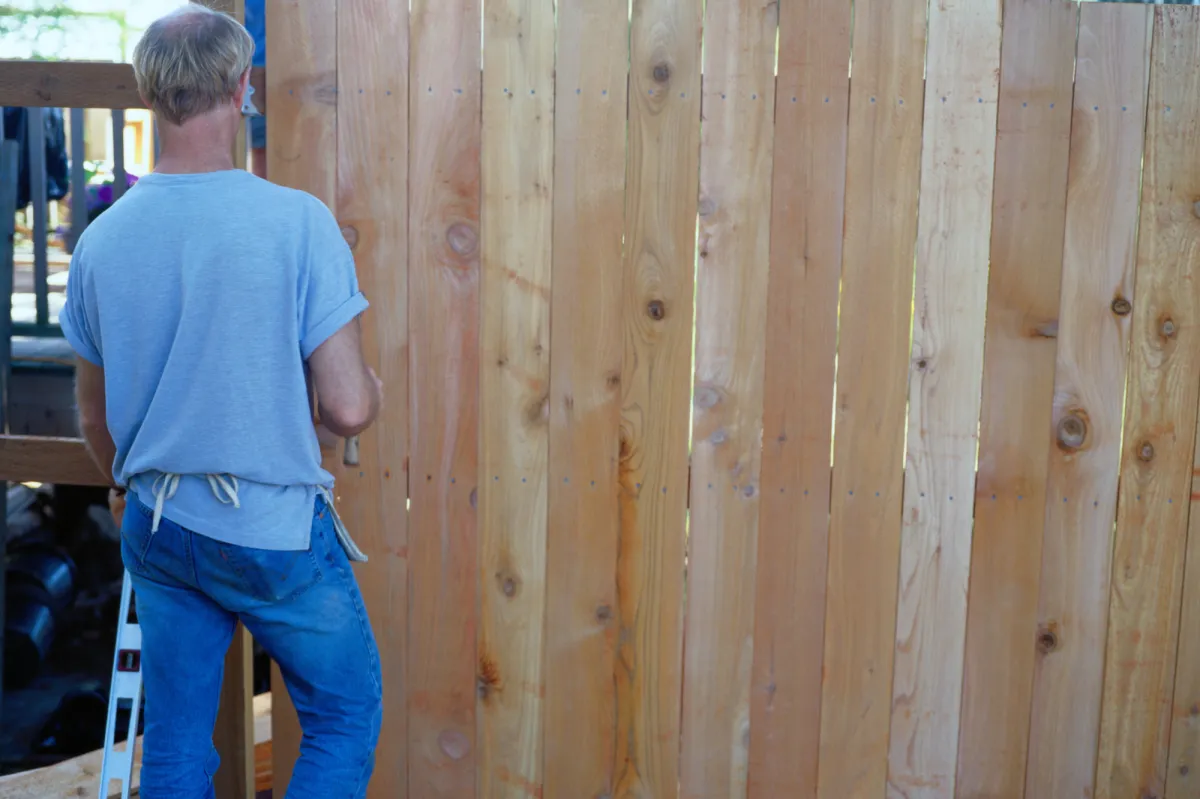 photo of worker installing a wood fence in Weston, FL