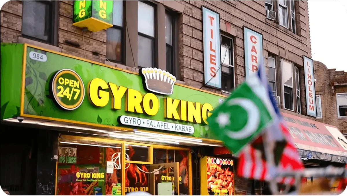 Cinematic hero shot of a sizzling gyro wrap being sliced with steam rising.