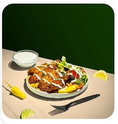 Chicken Souvlaki Bowl with char-grilled chicken and lemon wedge